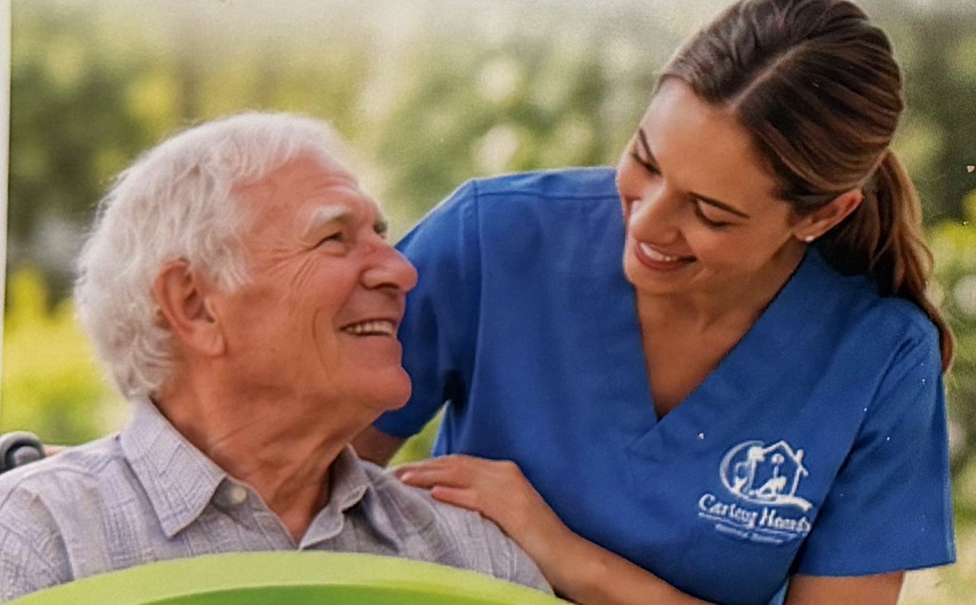 A caregiver in blue scrubs sharing a smile with a senior man