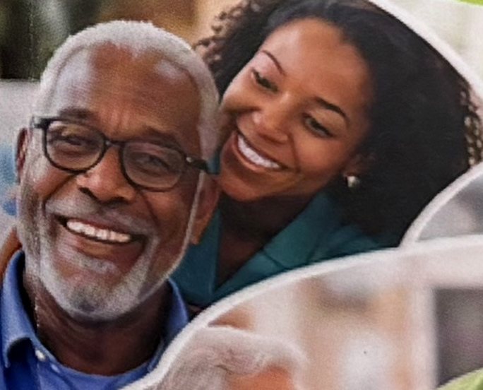 A smiling senior man with his caregiver